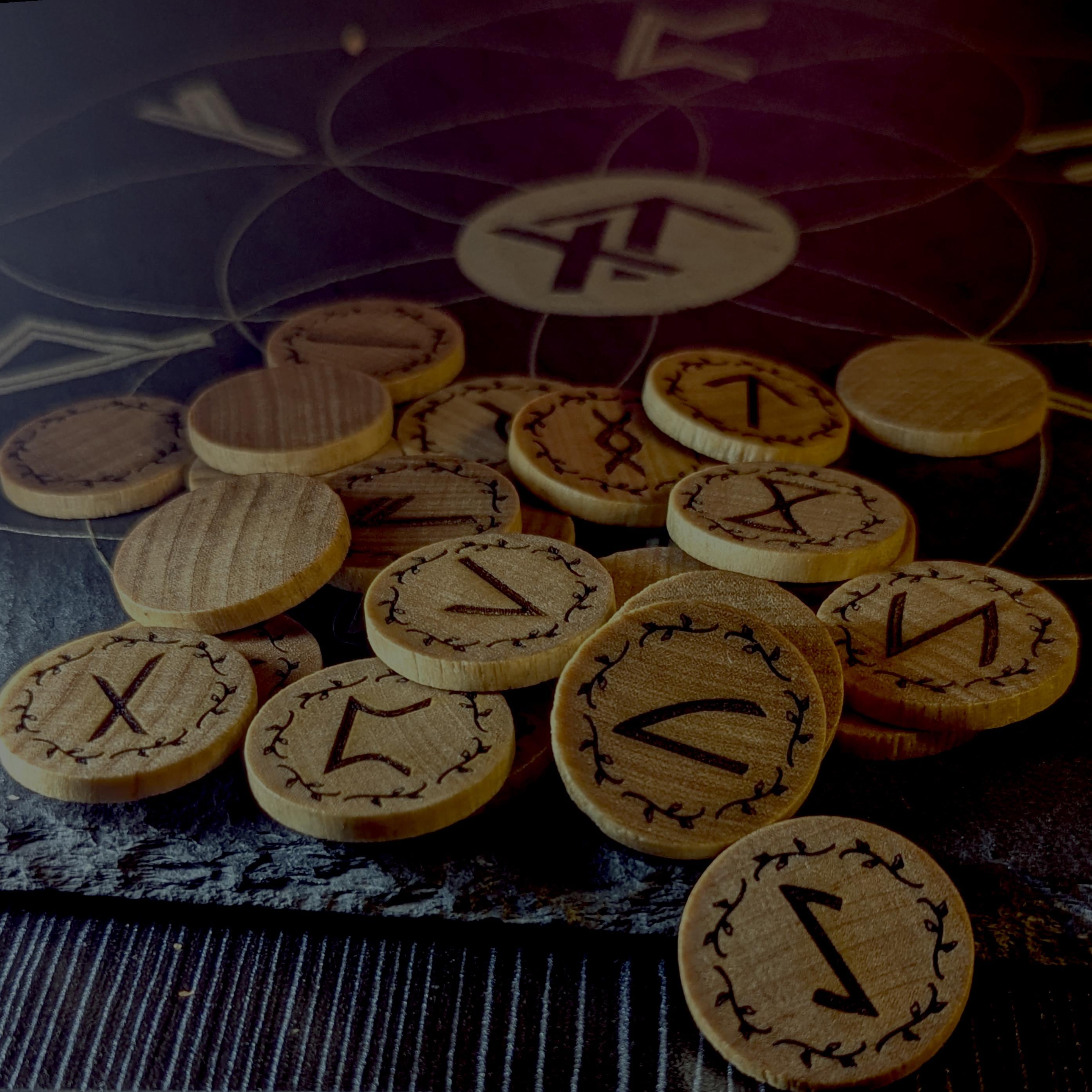 Elder Futhark Rune Set, hadcrafted from hardwood in Canada, on a stone surface with the True North Runes Logo visible.