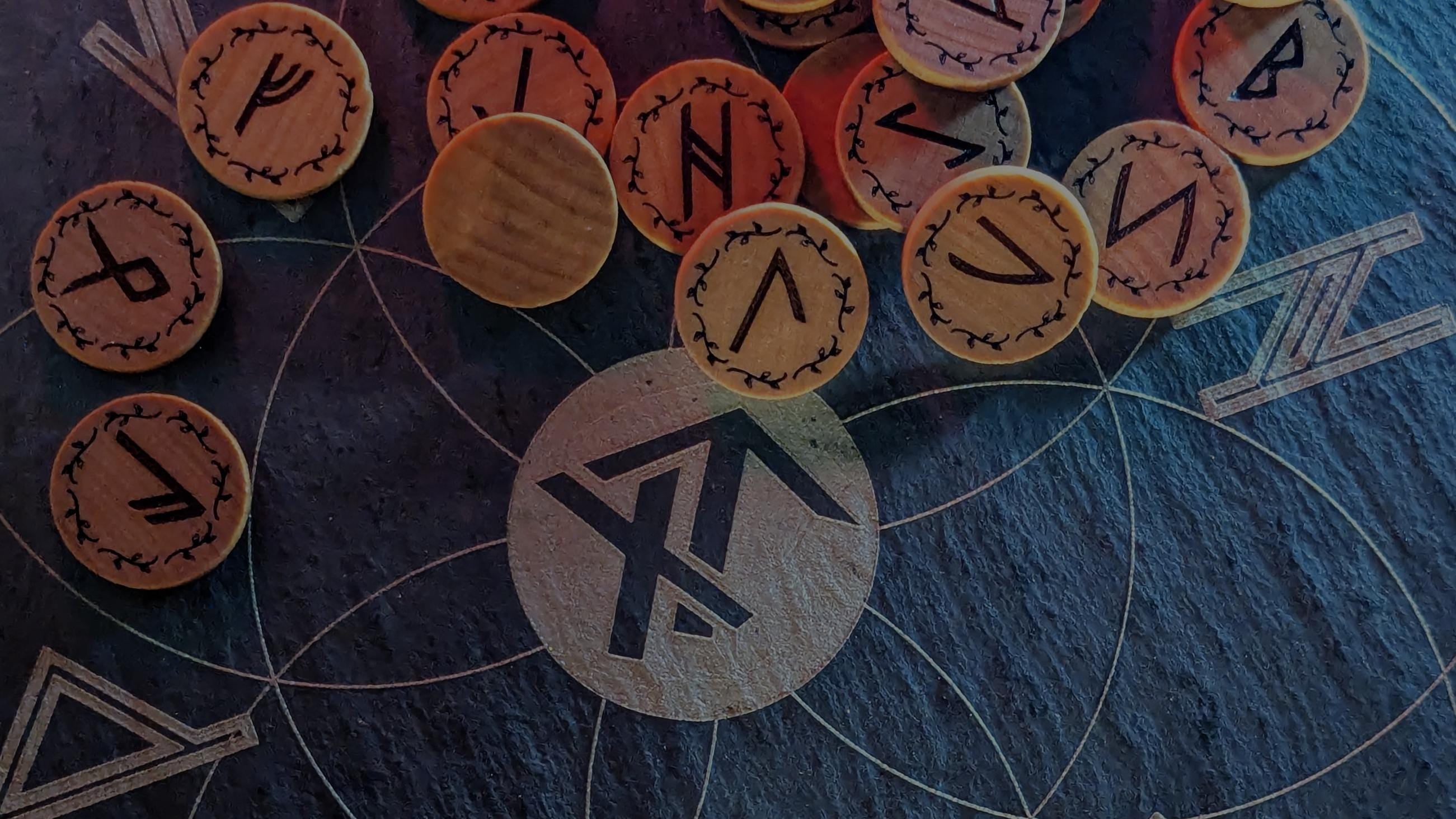 Set of Elder Futhark runes on a dark surface with True North Runes logo