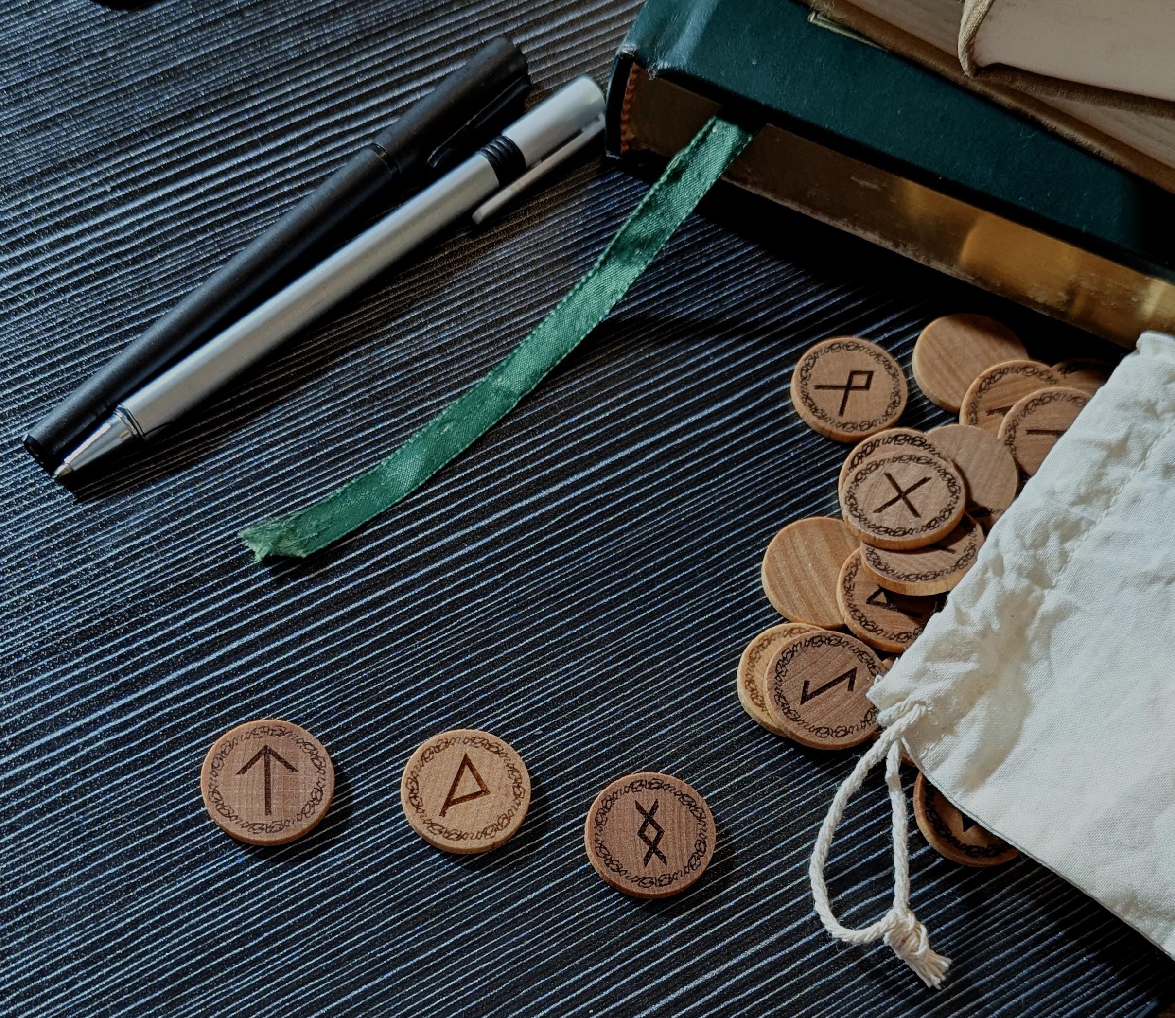 Elder Futhark Rune Set Displayed on Table. Handcrafted in Canada, engraved on real hardwood.