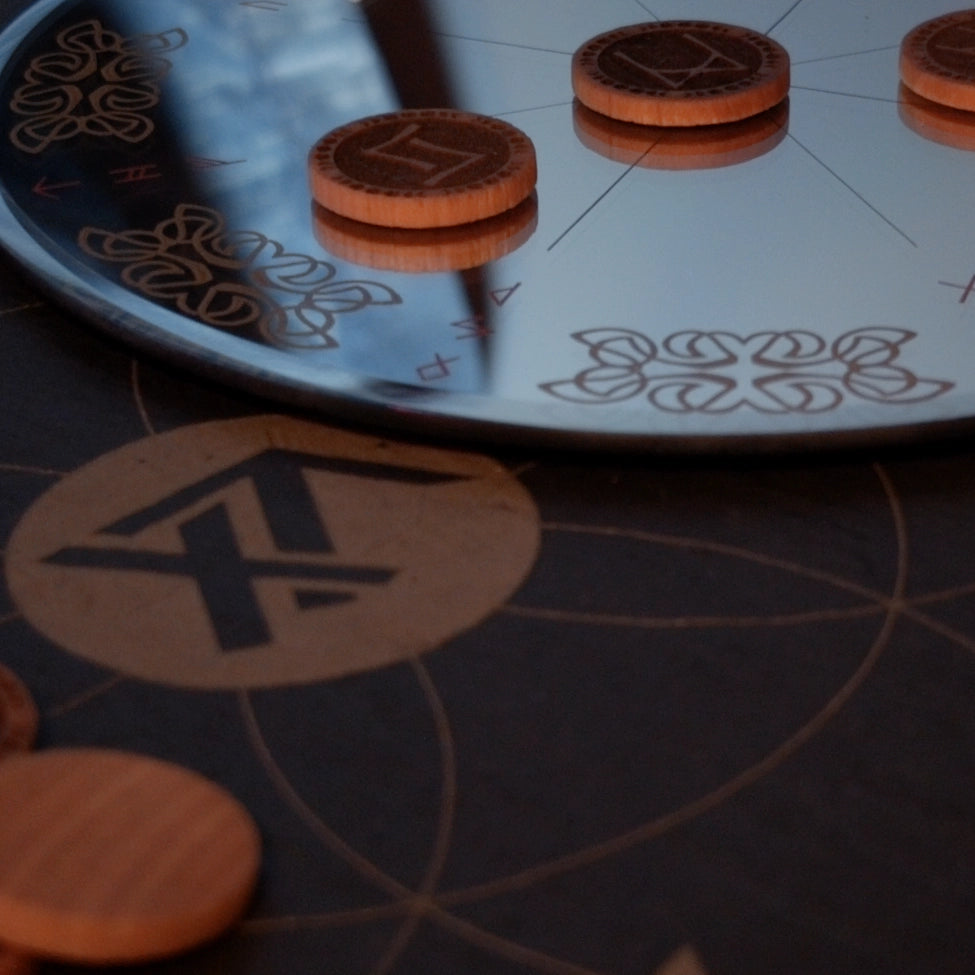 Wood Elder Futhark Runes on an engraved mirror overlapping True North Runes' Logo